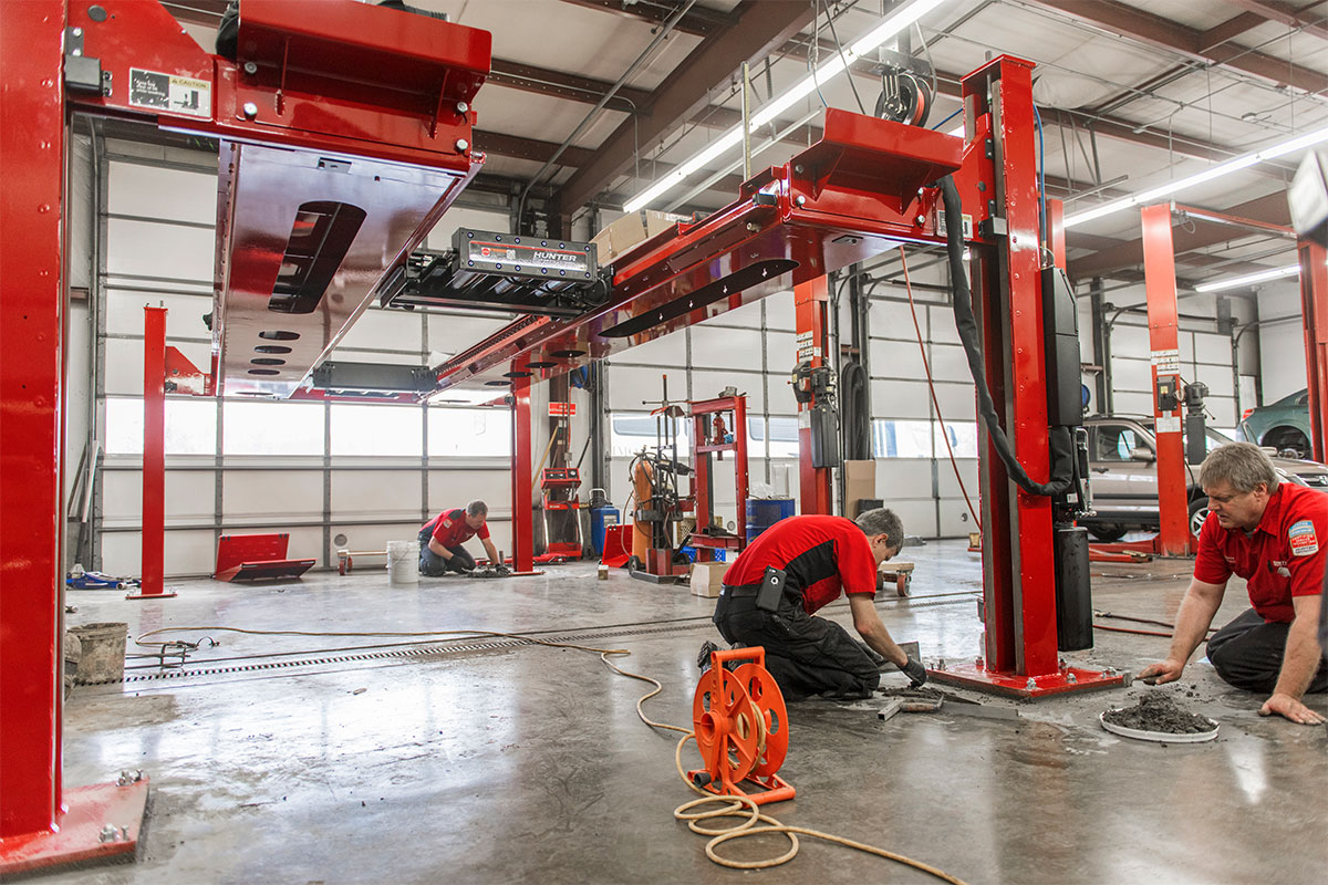 rack-l45x-install-hemannautomotive5.jpg service reps cementing four post lift to floor