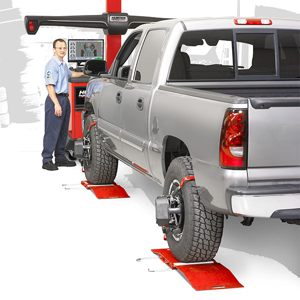 technician performing collision alignment on flat floor with turnplates