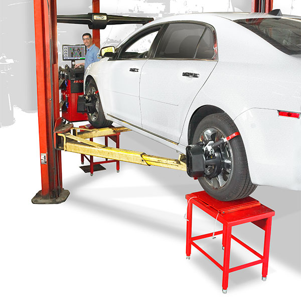 technician performing collision alignment with hawkeye elite and two post lift