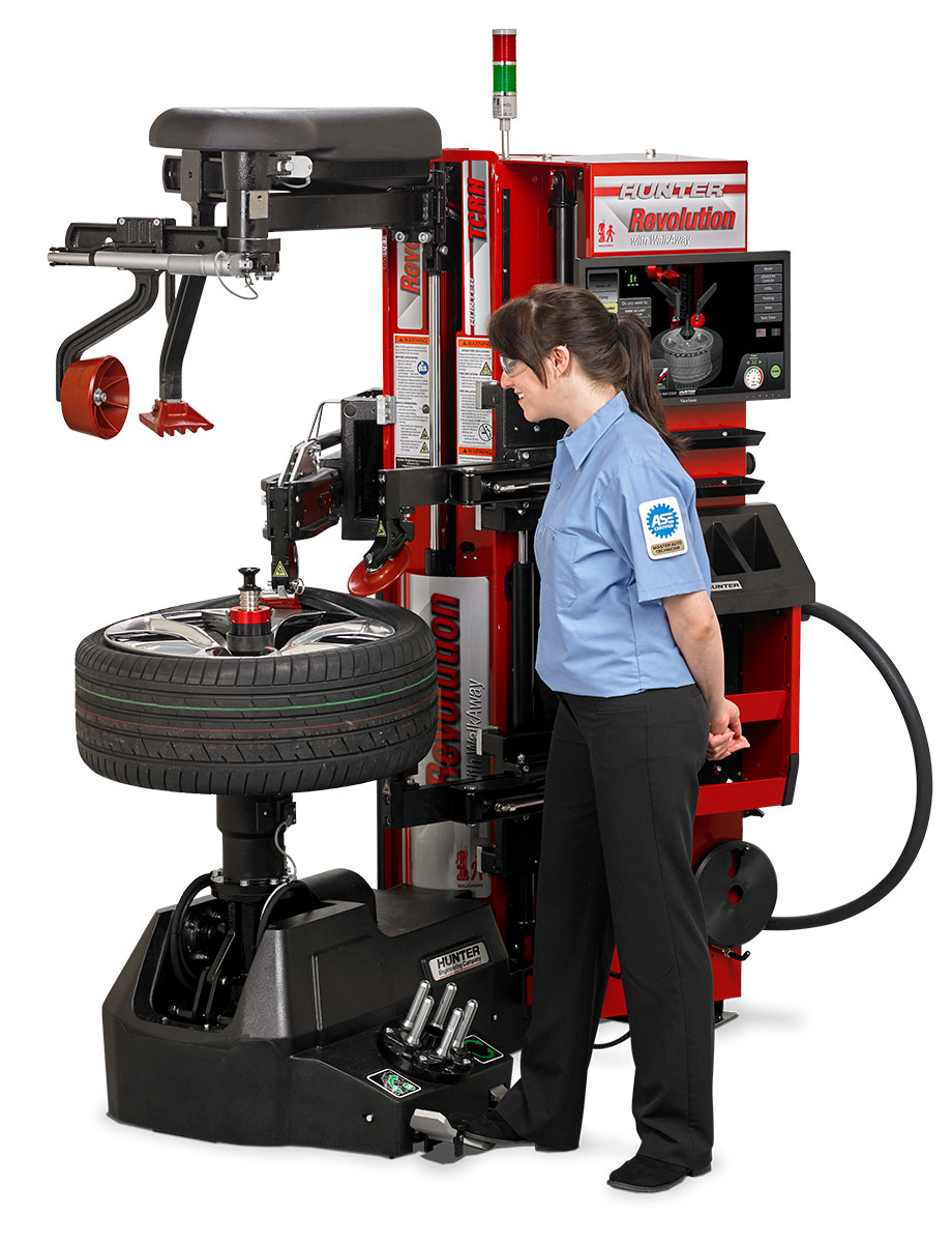 technician operating autonomous tire changer