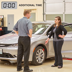 two people speaking in service drive about car